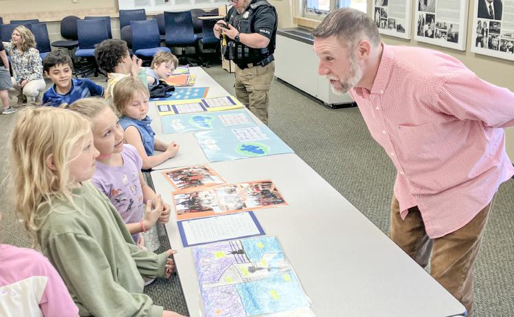 Beaverton Elementary School Teacher Matt Collins guided his first graders through a public display of learning Monday at the Beaverton Activity Center.