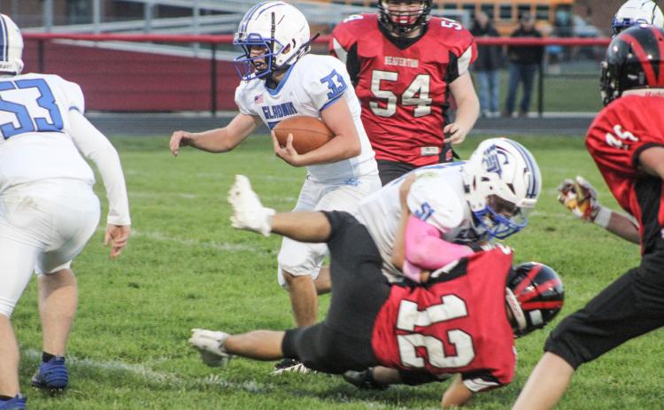 Gladwin’s Max Barz blocks Beaverton’s Nate Diamond to create running room for Ryan Quick during the Flying G’s junior varsity victory. BEAVERTON