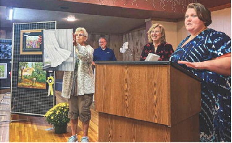 Gladwin High School Art Instructor Amber Billman awarding ribbons at the annual Fall Art Show.