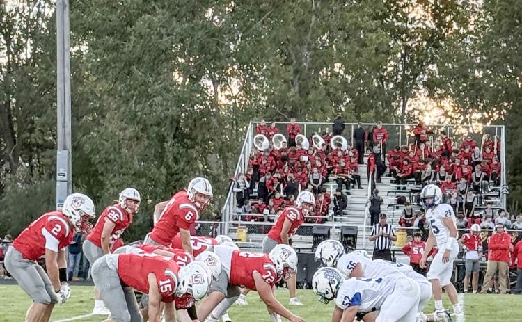 The Gladwin defense digs in prior to the snap on a rough night at Spring Lake. The Flying G’s will shoot for their first win Friday night when they host Jack Pine Conference rival Ogemaw Heights.