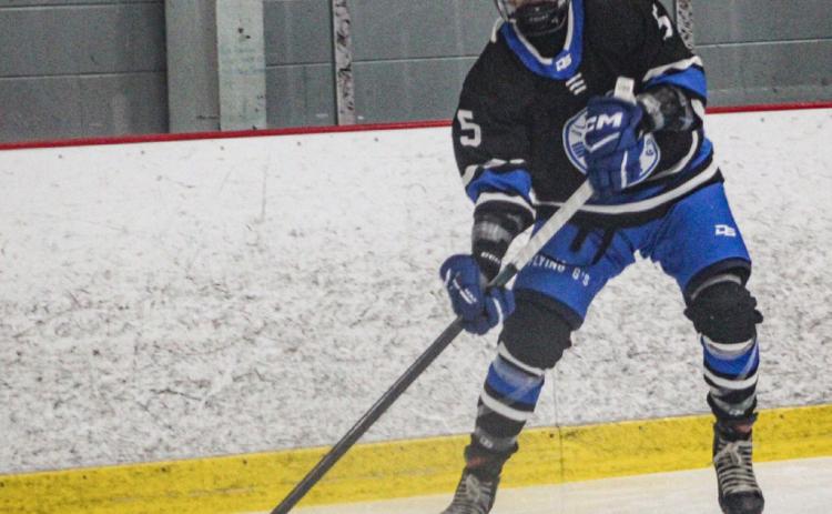 Gladwin’s Caden McKeever sends a pass toward the front of the net during a recent game.