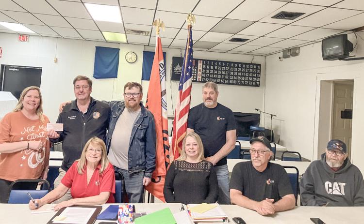 Gladwin County Office of Veterans Affairs Director Ken Roberts (back row, second from left) accepts a donation from the officers of the Gladwin Eagles 3292 Riders at a meeting of the club Friday night