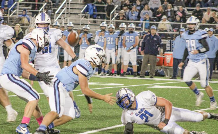 Gladwin’s Matthew Lechner forces a fumble up into the air that was eventually recovered by Kaden Reid during Friday night’s victory at Meridian.
