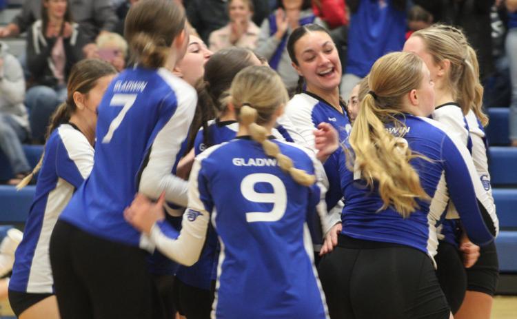 Gladwin’s volleyball team whoops it up after knocking off Clare in the district semifinals last Wedensday night.
