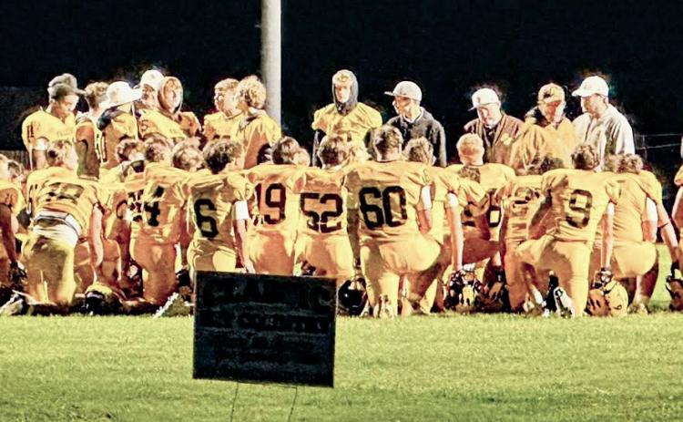 The Ogemaw Heights football team hears words of encouragement after Friday night’s loss to Traverse City St. Francis.